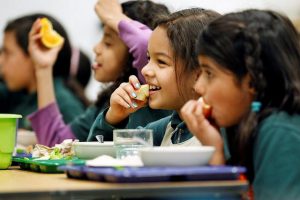 Four girls eating their lunch at school