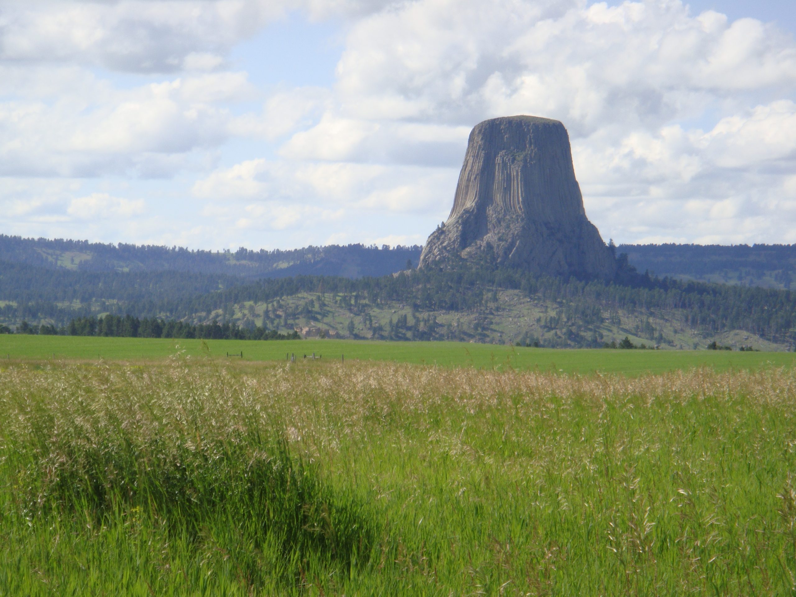 It is a steep rock jutting out of the countryside.