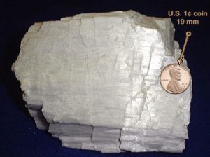 Image of wollastonite, a crystal showing step-like cleavage on one side. All steps are along the same direction of cleavage.
