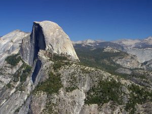 View showing an expansive area of a mountain range with exposed white granite in many places.