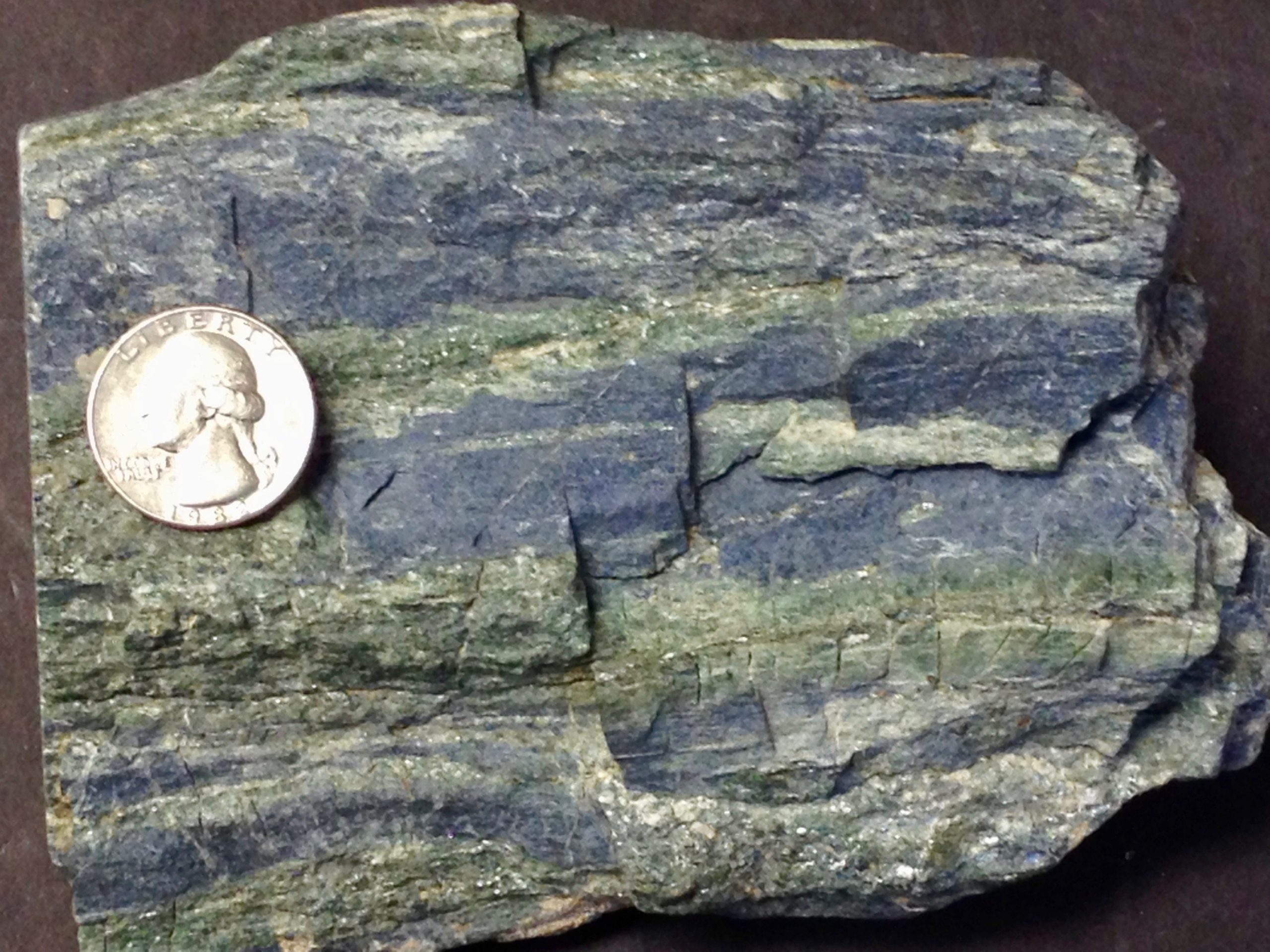 Source: Peter Davis A blue rock with bands of silvery mica grains.