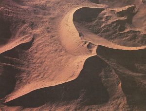 Source: USGS image in the Public Domain a dune iwth a central peak and many ridges formed by shifting winds