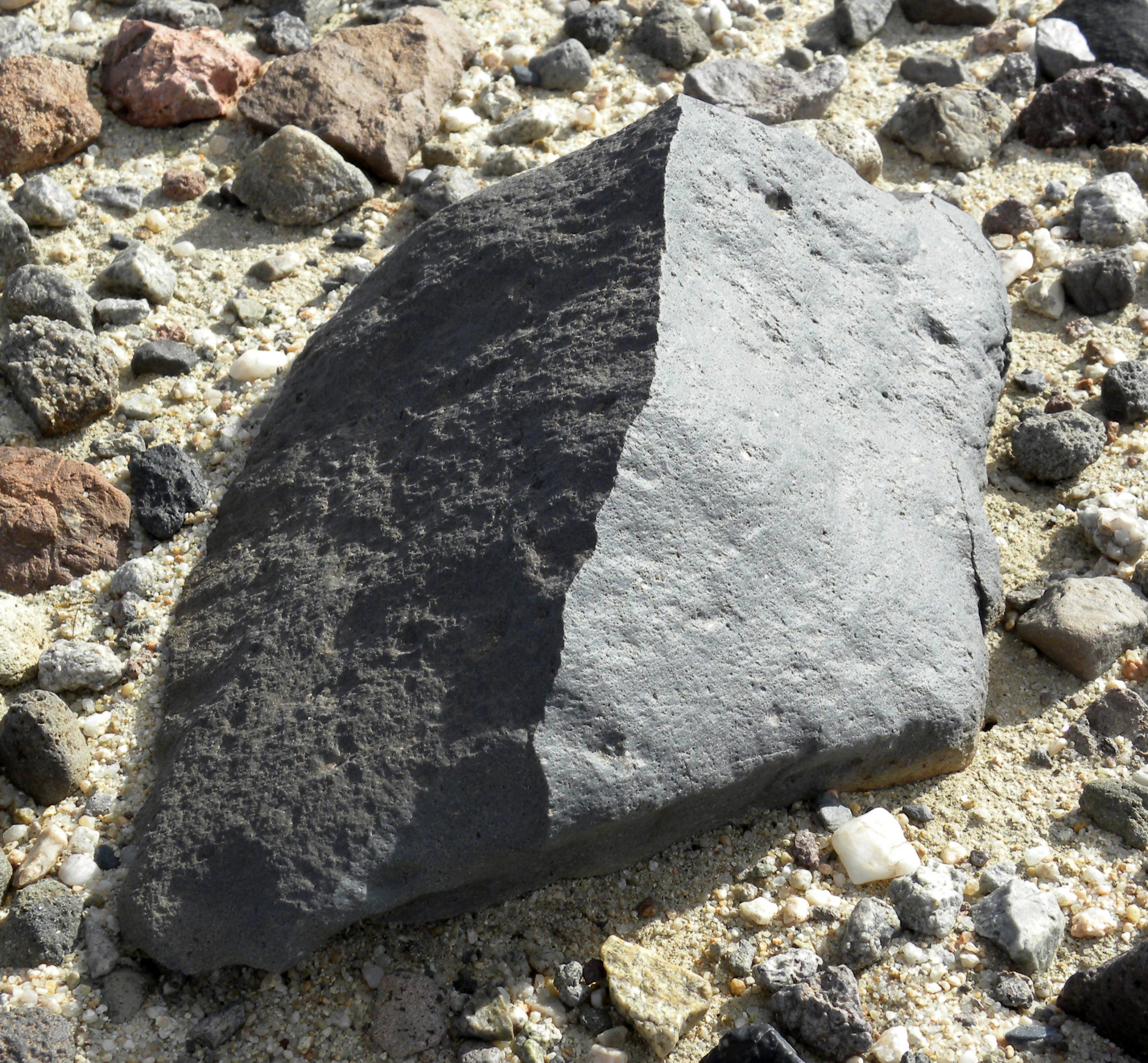 "Source: Rock on desert floor polished on multiple sides by sandblasting.