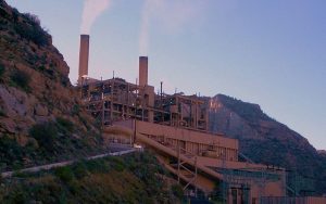 The power plant has smoke coming from it