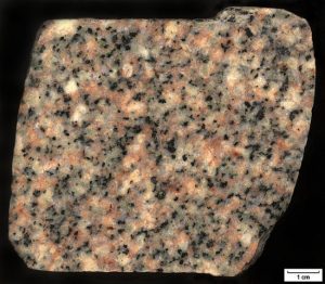 Photograph of cut granite. showing a variety of visible minerals, including quartz and k-feldspar.