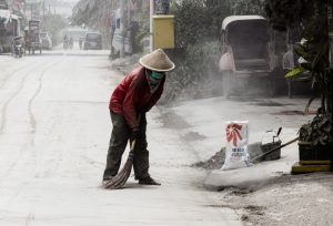 The man is wearing a mask to prevent pneumonoultramicroscopicsilicovolvanoconiosis.