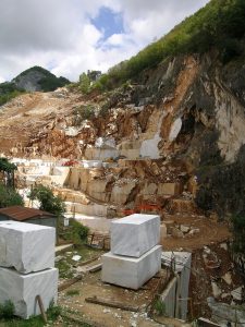 "By The image shows a hillside with blocks of marble removed.