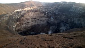 The crater has white rocks in the walls
