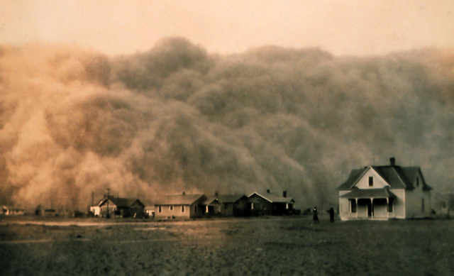 The black and white photo shows a giant wall of dust.