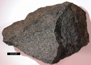 Dark rock with visible crystals.