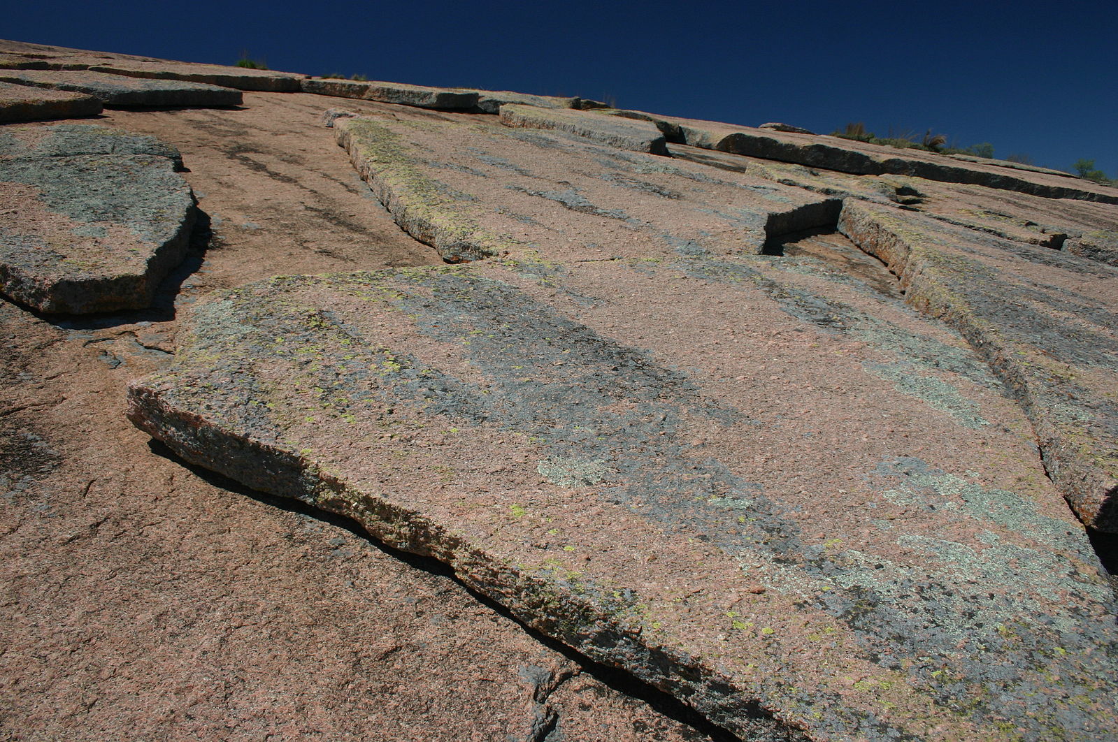 Granite rock has a relatively thin layer that is peeling away
