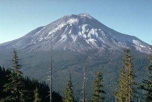 The volcano is conical and forested.