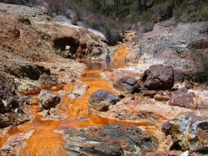 "By The water in the river is bright orange.