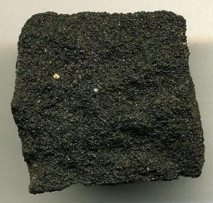 "By The sandstone is black with tar.