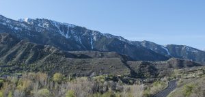 Large linear hills composed of till, aligned with the "U" shaped mouths of canyons.