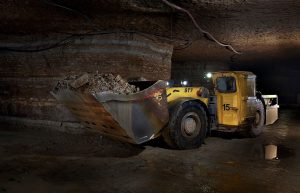 A large truck is loading material underground.