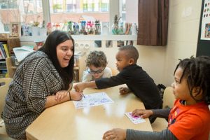 preschool teacher with 3 students