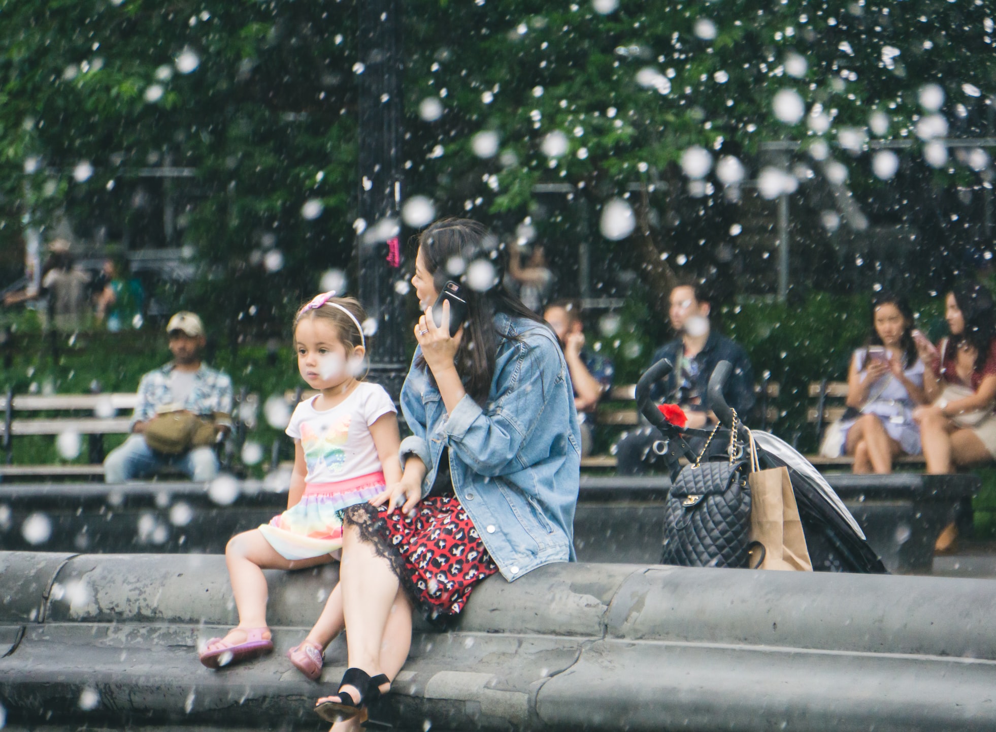 Image shows an adult and child sitting together.