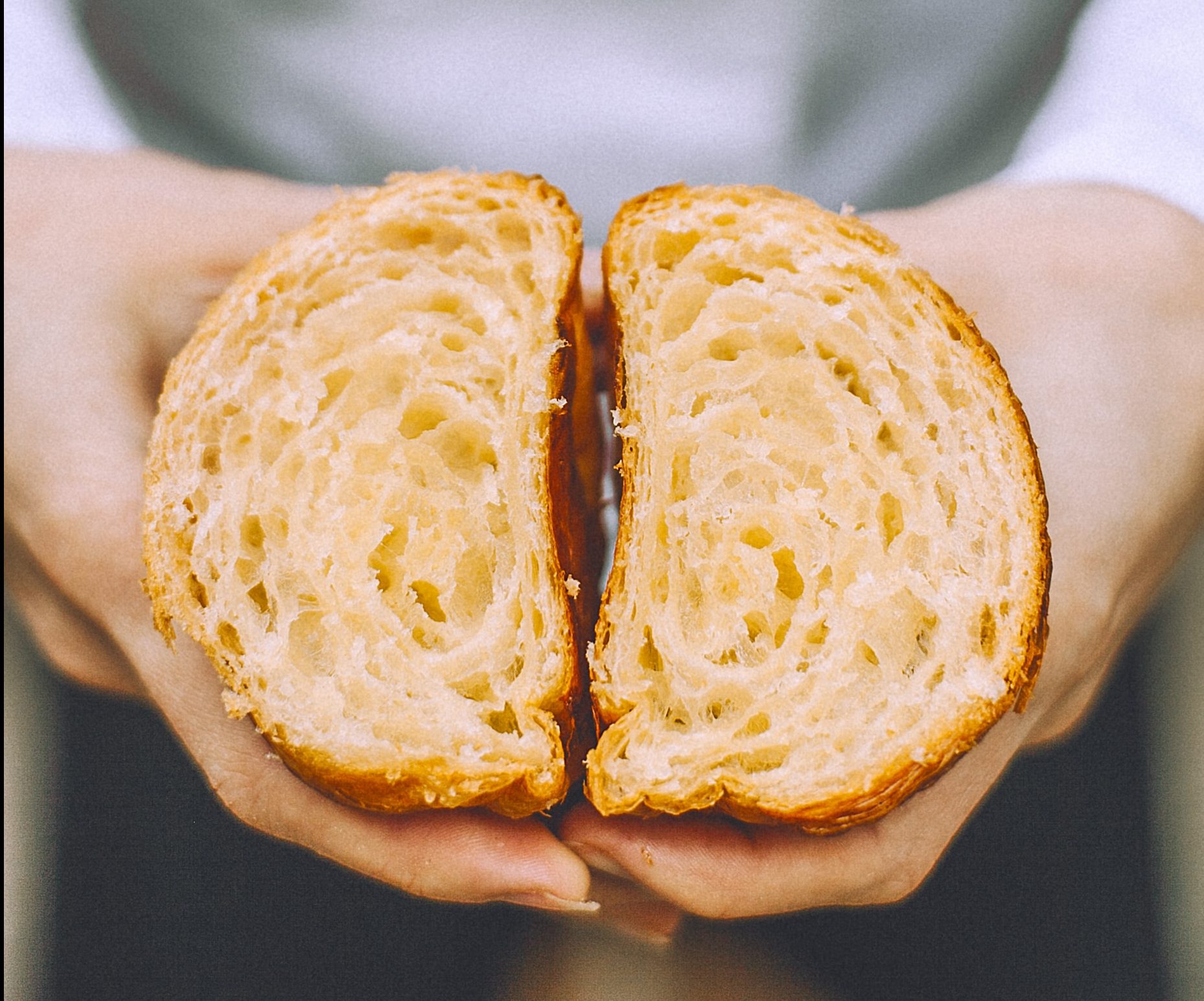 Image shows a close up view of a slice of bread. There are holes in the bread created by bubble of carbon dioxide.