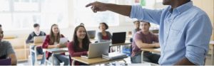 High school teacher calling on student in classroom
