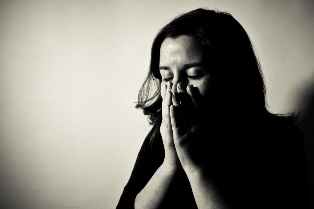 “4347213145_bec129a6ae.jpg” by Michael Clesle is licensed under CC BY-NC 2.0 Photo showing a woman with hands to face