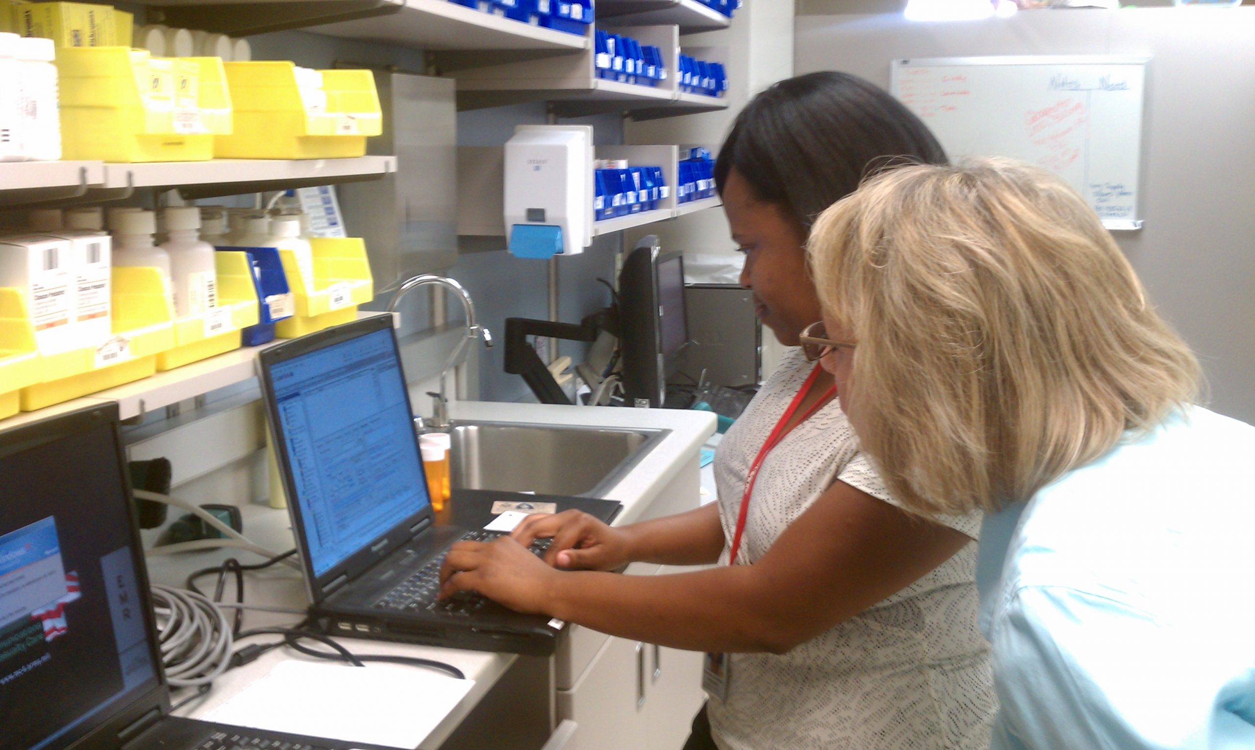 "Winn_Army_Community_Hospital_Pharmacy_Stays_Online_During_Power_Outage.jpg" by Flickr user MC4 Army is licensed under CC BY 2.0 Image showing nurses looking at electronic health record