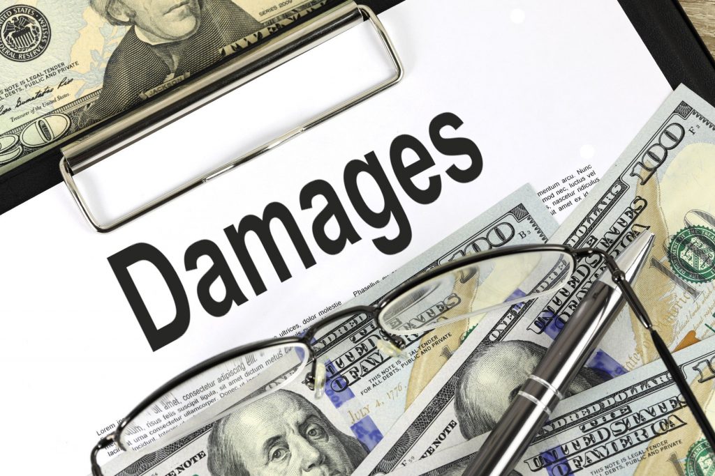 “damages.jpg” by Nick Youngson hosted by Pix4free is licensed under CC BY-SA 3.0 Image showing eye glasses, pen, and paper money on top of a clipboard with paper that states Damages