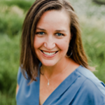 Leah is a middle aged woman with shoulder length brown hair. She is white-skinned and wearing a light blue shirt