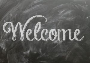 Whiteboard with handlettered "Welcome" written.