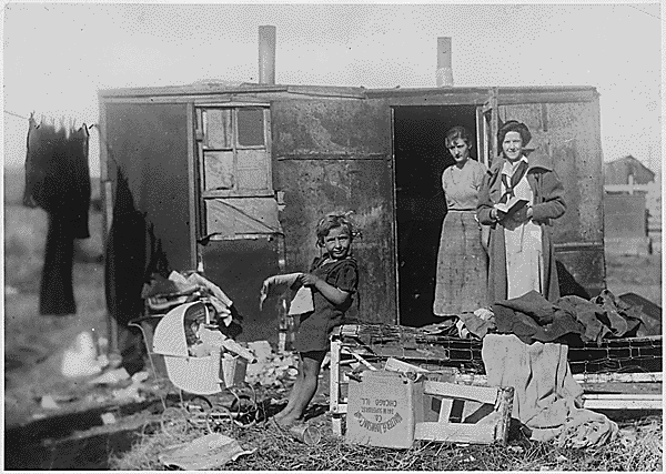 Makeshift nursing health station made with scrapped parts, with nurses standing nearby