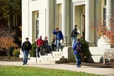 A picture of college students outside of a building.