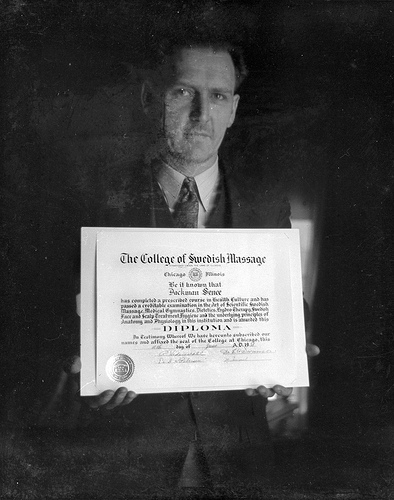 Image of a man holding a diploma.