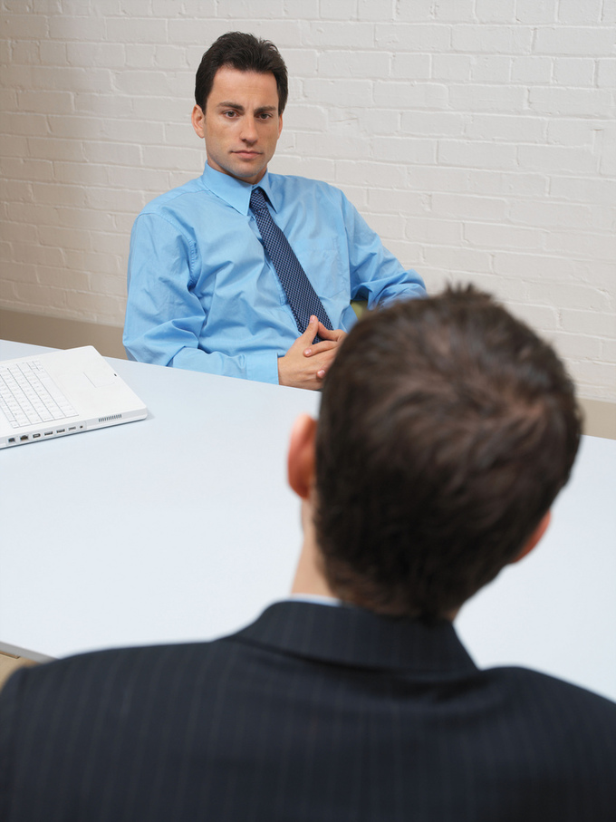 Two Businessmen Having a Discussion: These two businessmen could represent a manager and shareholder discussing the operation of the business.