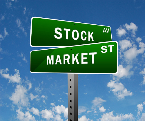 Image of crossed street signs. One reads stock and the other market.