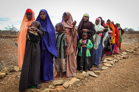 omen and children waiting to enter a medical clinic in Somalia.