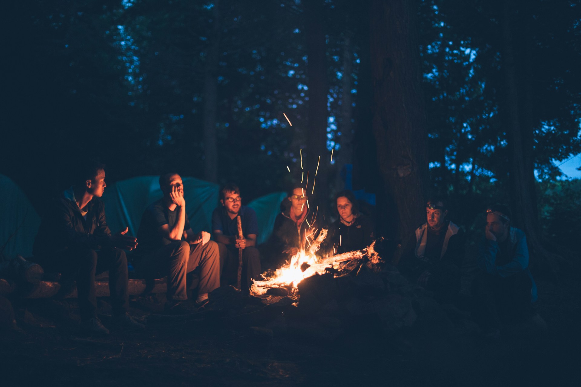 People talking around a campfire