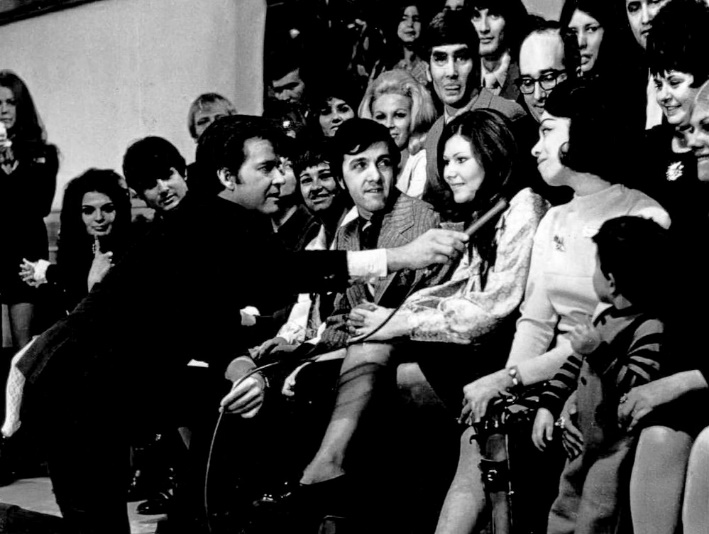 Dick clark talks to Myrna Horowitz, one of the original dancers when the program began in 1952, on the show's 18th anniversary in 1970.