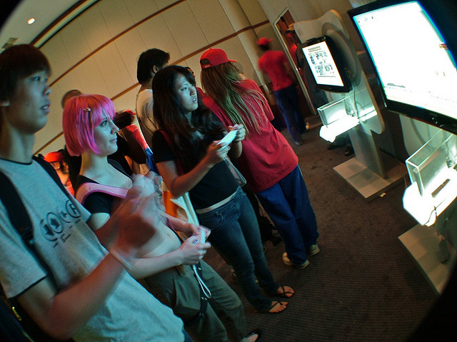People playing team video games at a convention.