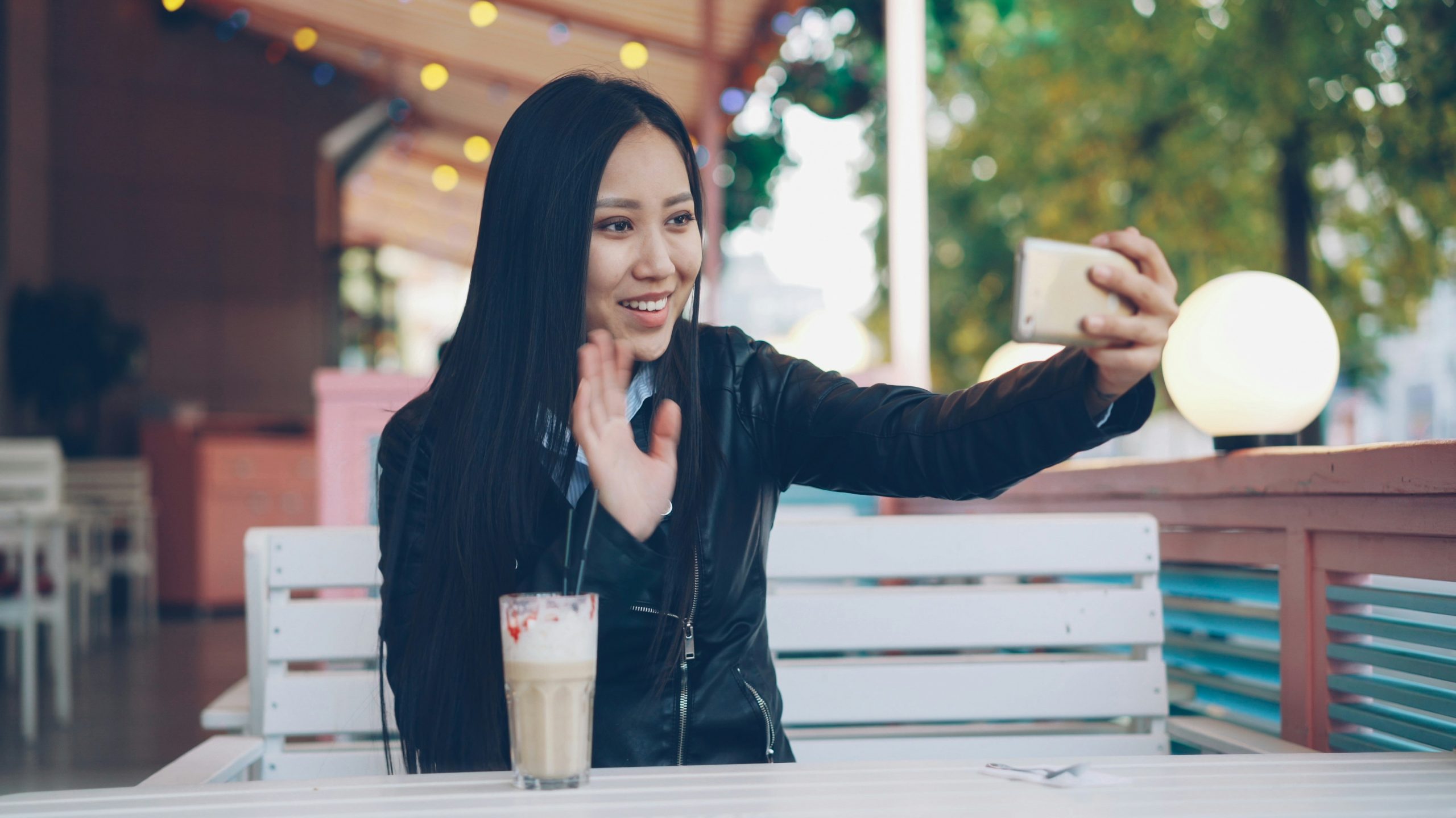 Young woman taking a selfie with her phone