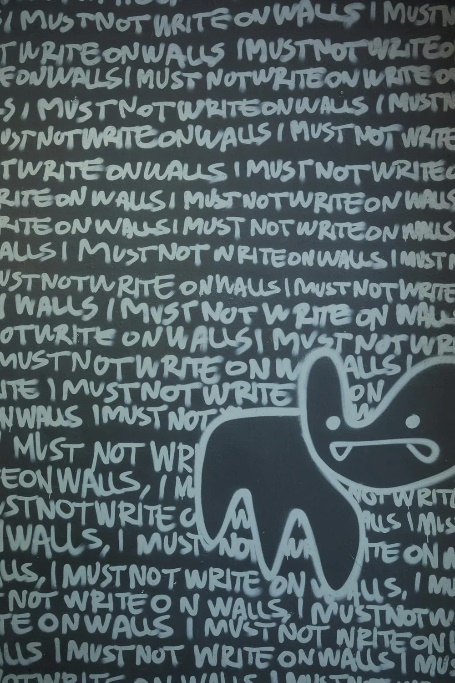 Abstract drawing of a cat standing in front of a wall that says "I must not write on walls."