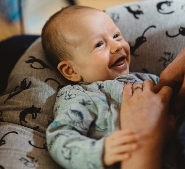 Smiling baby in bassinet