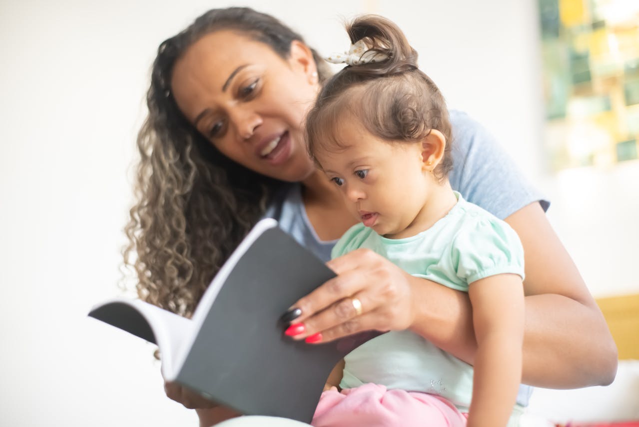Mother and baby girl reading a book