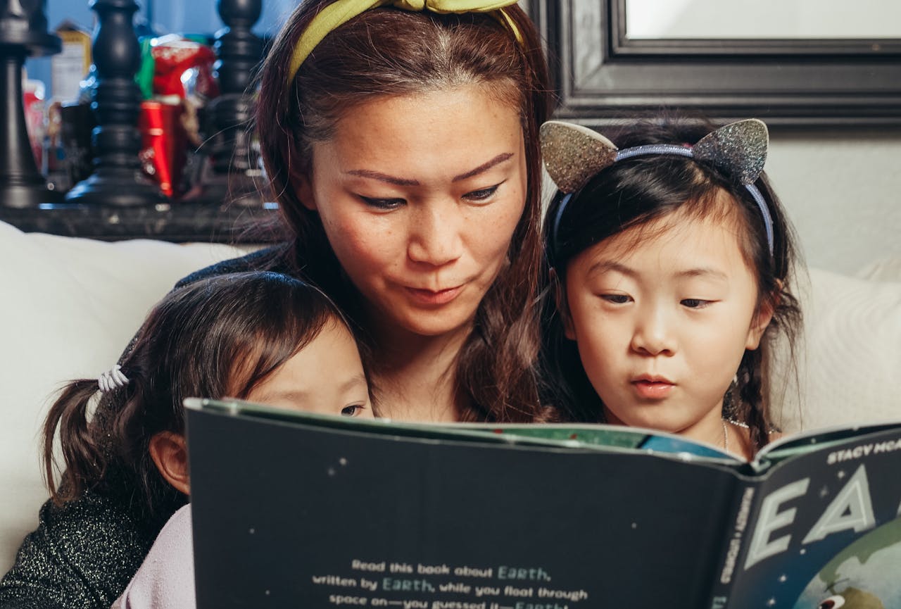 Mother and children reading together.