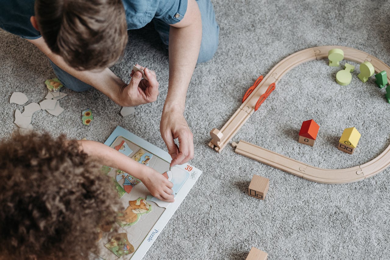 Children playing with puzzles and a train set.