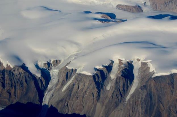 Part of the continental ice sheet in Greenland, with some outflow alpine glaciers in the foreground.