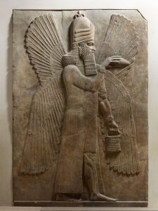 A strong man with wings and a plaited beard holds a bucket in his left hand.