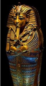 A gold coffin with shaped like a mummy and inlaid with lapis lazuli and coral.