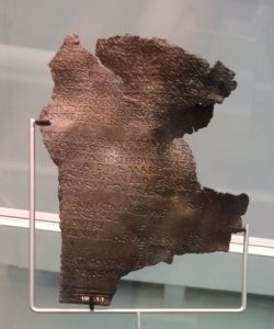 A bronze sheet with words inscribed on it.