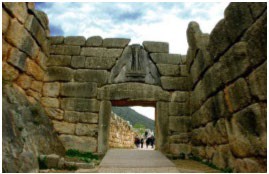A stone post and lintel gate with two lions carved in the arch shaped stone at the top.