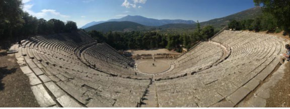 A view from the semi-circular stone seating added by the Romans and the circular orchestra where the music and dance probably took place.